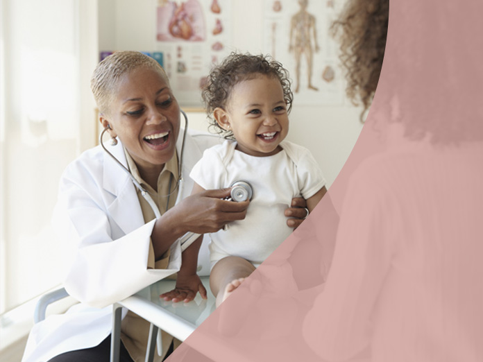 Doctor smiling checking smiling baby