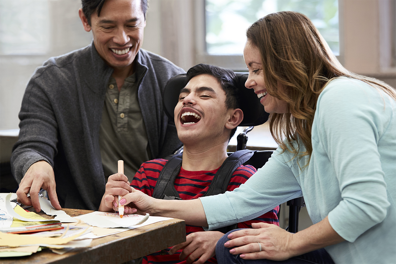 Parents color with their Handicapable son