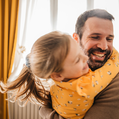 A man hugging his daughter