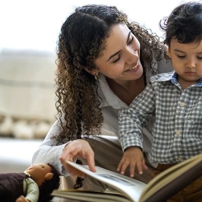 A woman and toddler reading a book